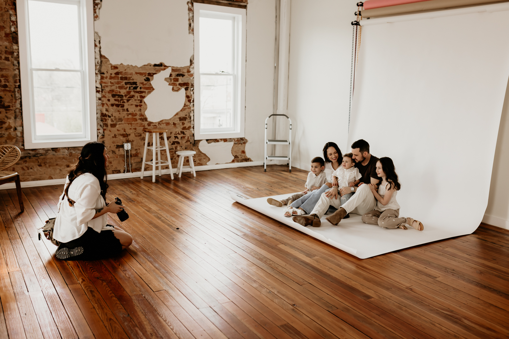 Photographer working with a family at a studip