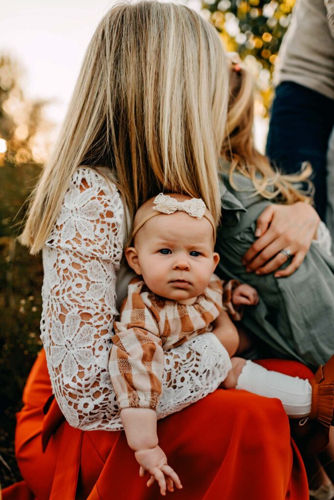 Mom holding baby girl during a family photo session