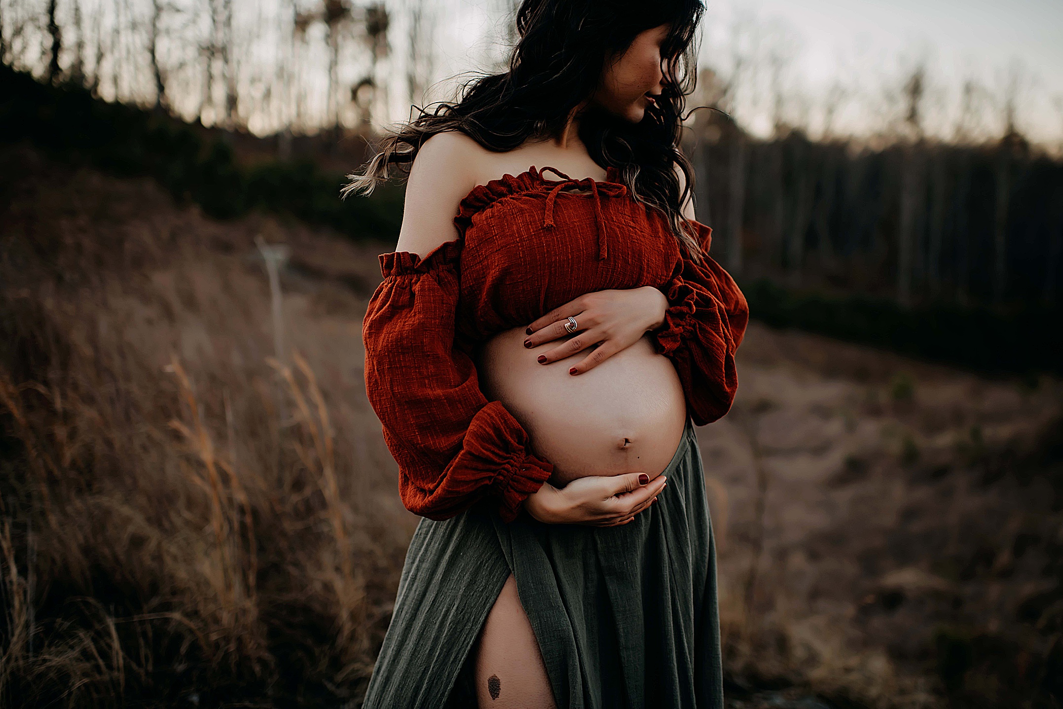 Mother holding her baby bump for photos.